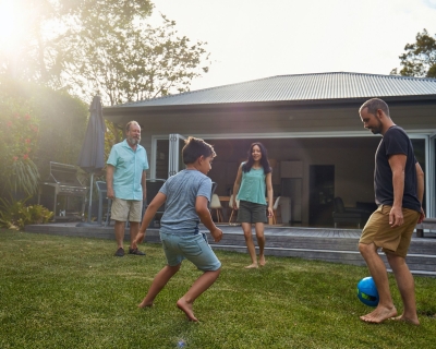Family playing soccer outdoors Family playing soccer outdoors